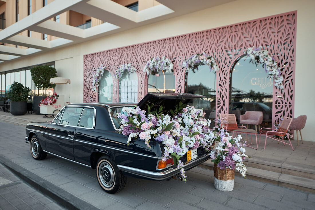 Flower Corner's classic wedding car dressed with fresh flowers