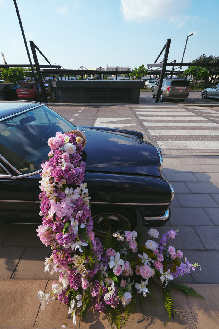 Flower Corner's classic wedding car dressed with fresh flowers